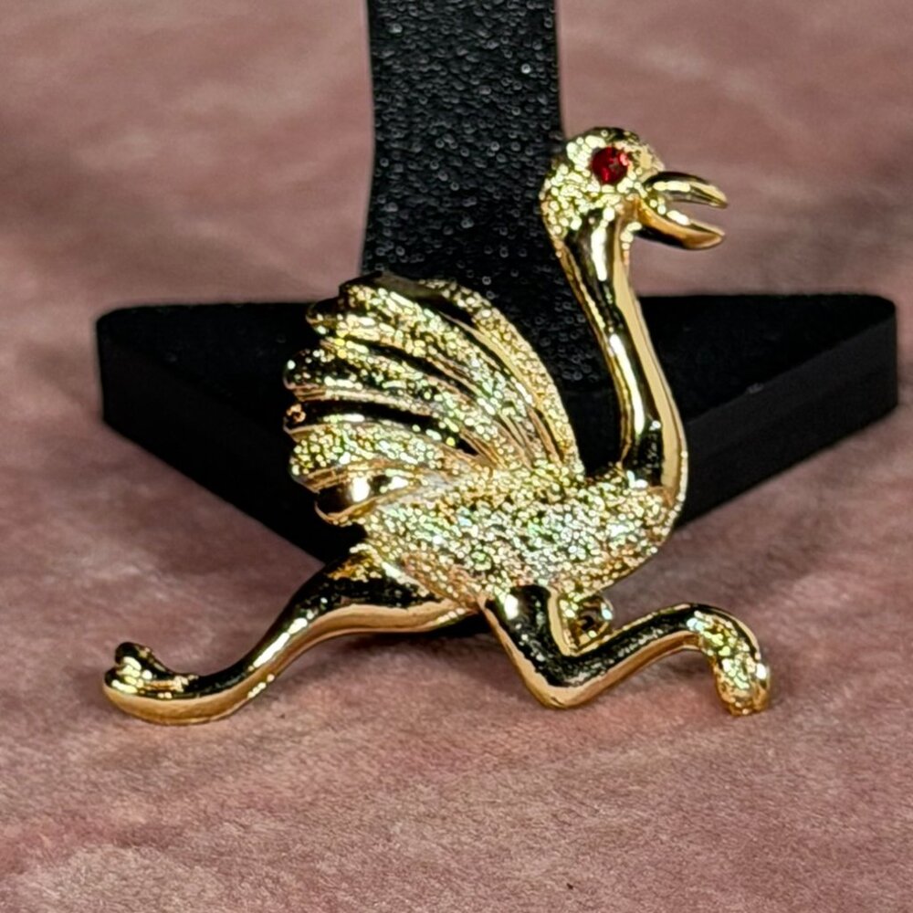 Vintage Gerry's Gold-Tone Ostrich Brooch with Ruby Red Eye